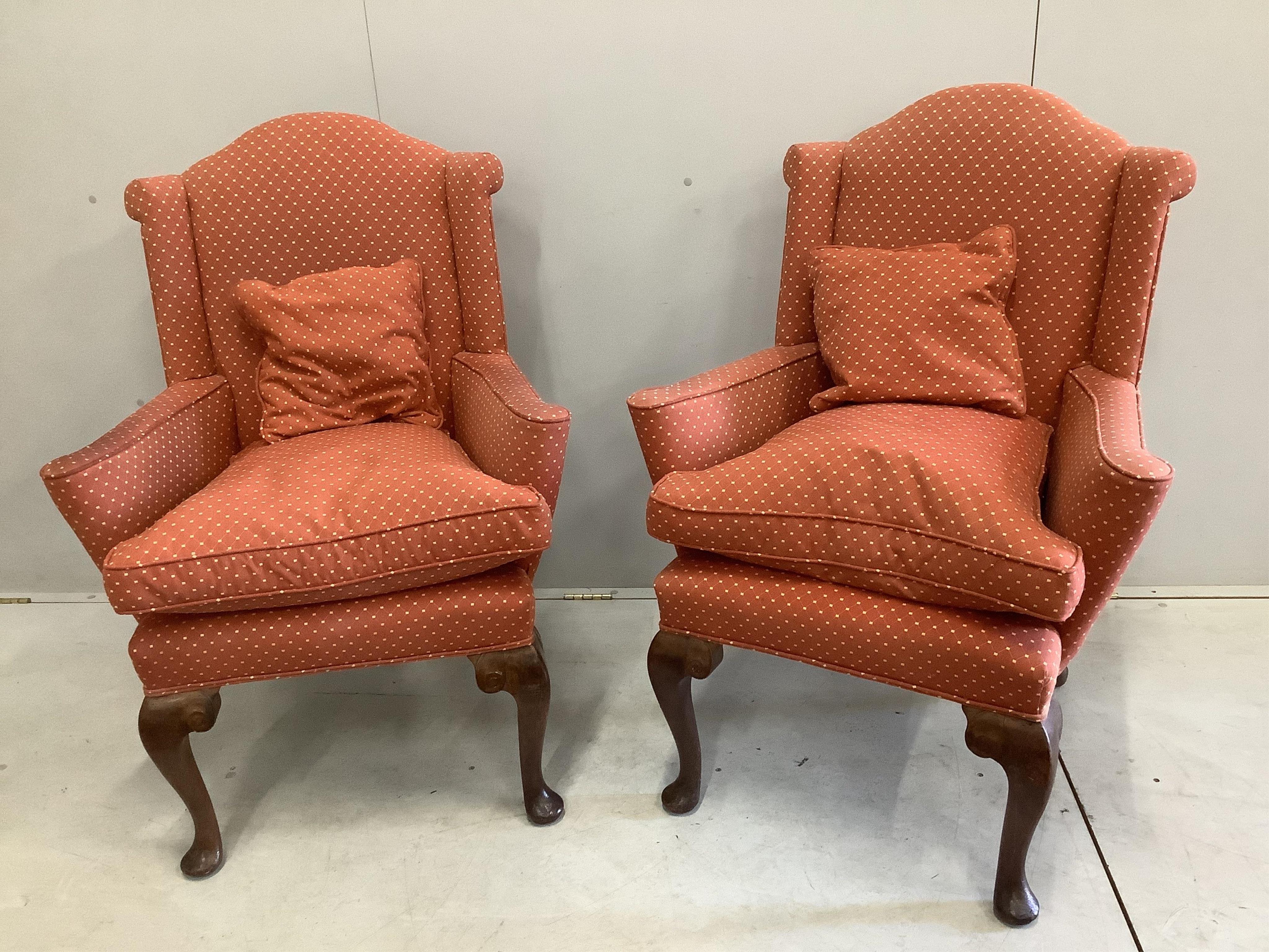 A pair of 1930's Queen Anne Revival walnut armchairs, width 78cm, height 107cm. Condition - slight fading to the top of the upholstery, minor rubbing to legs, fair to good